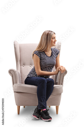 Young woman seated in an armchair looking away © Ljupco Smokovski