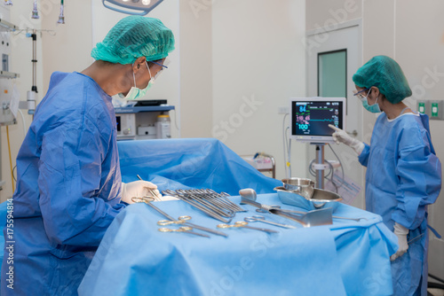 Asian doctor and an assistant in the operating room for surgical venous vascular surgery clinic in hospital.