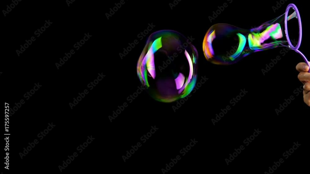 Hand making colorful soap bubbles background. Slow motion.
Hand making colorful soap bubbles background. Slow motion.