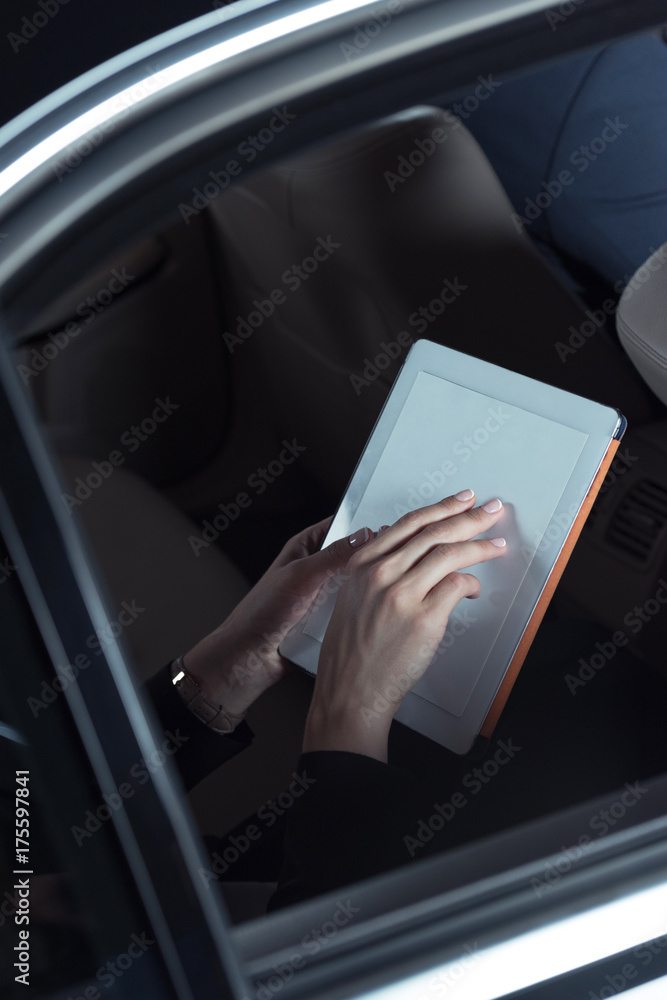 woman using digital tablet in car woman using digital tablet in car