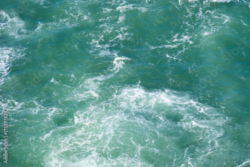 Wavy emerald ocean surface from above