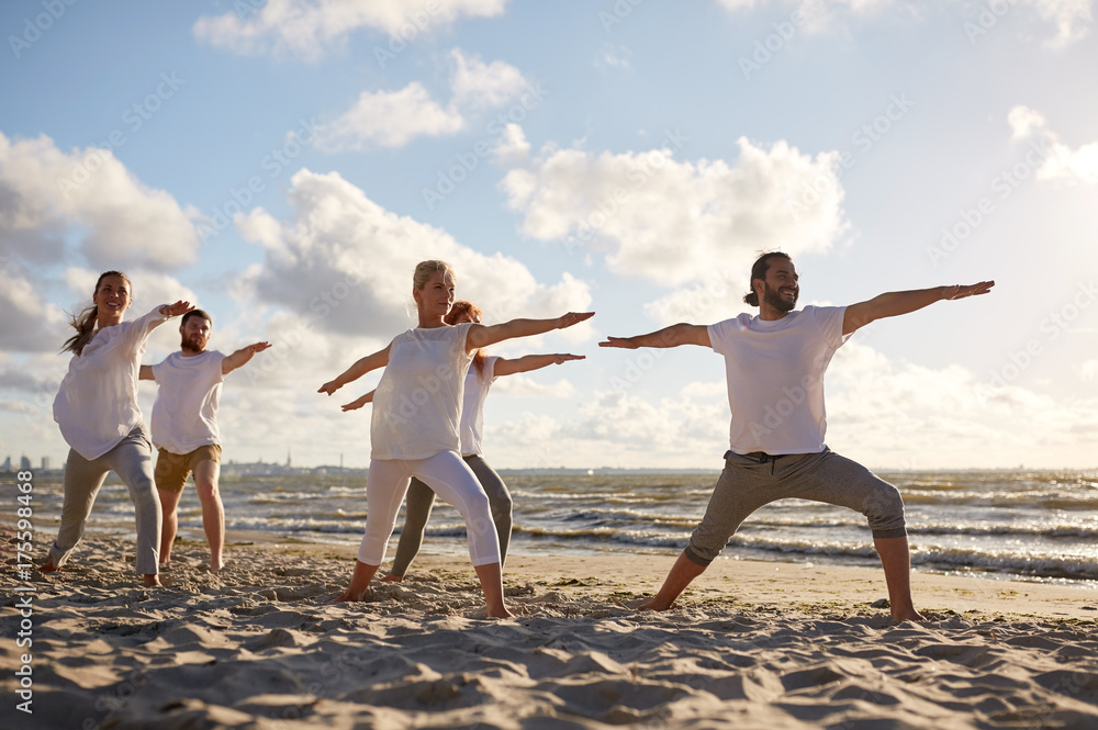 group of people making yoga exercises on beach group of people making yoga exercises on beach