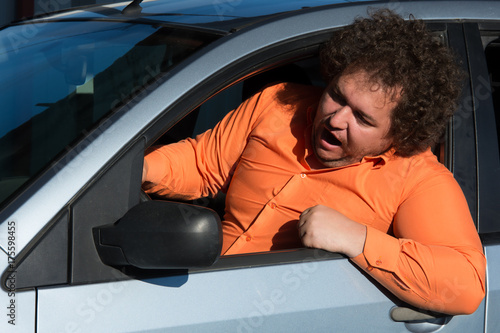 Fotografie Funny man in the car.