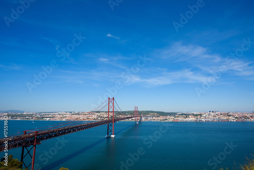 Red bridge The 25 de Abril Bridge in Lisbon Portugal over Tagus river at clear sunny summer day