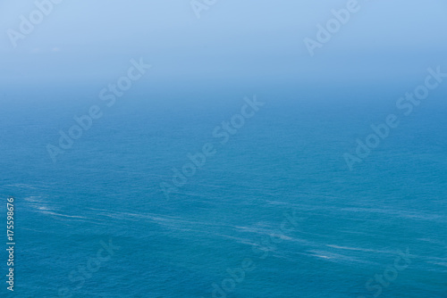 Aerial view of calm infinite ocean and blue sky background © nevodka.com