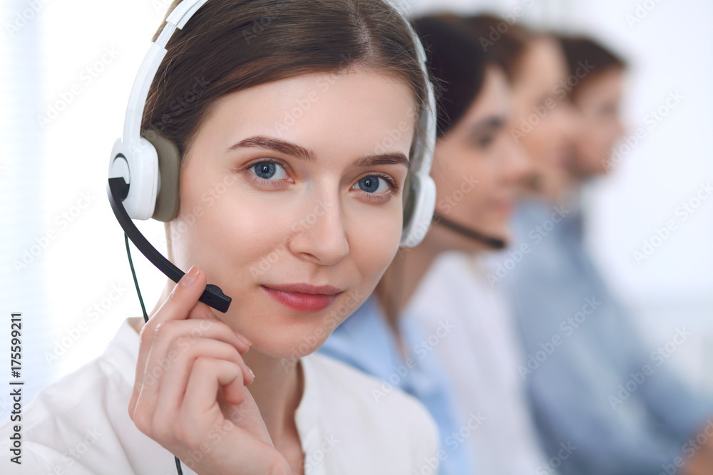 Call center operator.Young beautiful business woman in headset Call center operator.Young beautiful business woman in headset
