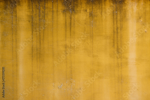 Old weathered yellow painted stucco wall texture © nevodka.com