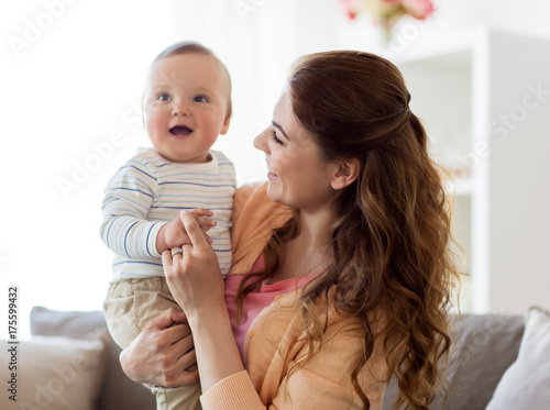happy young mother with little baby at home