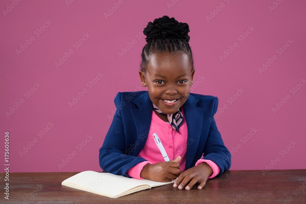 Portrait of smiling businesswoman writing report Portrait of smiling businesswoman writing report