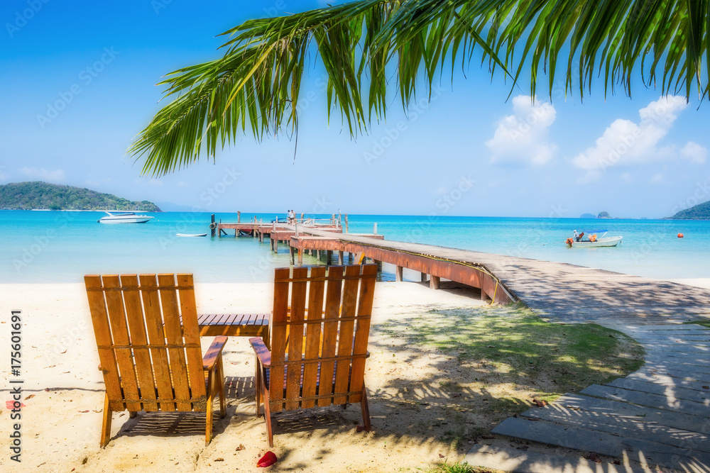 Two beach chairs on idyllic tropical sand beach.