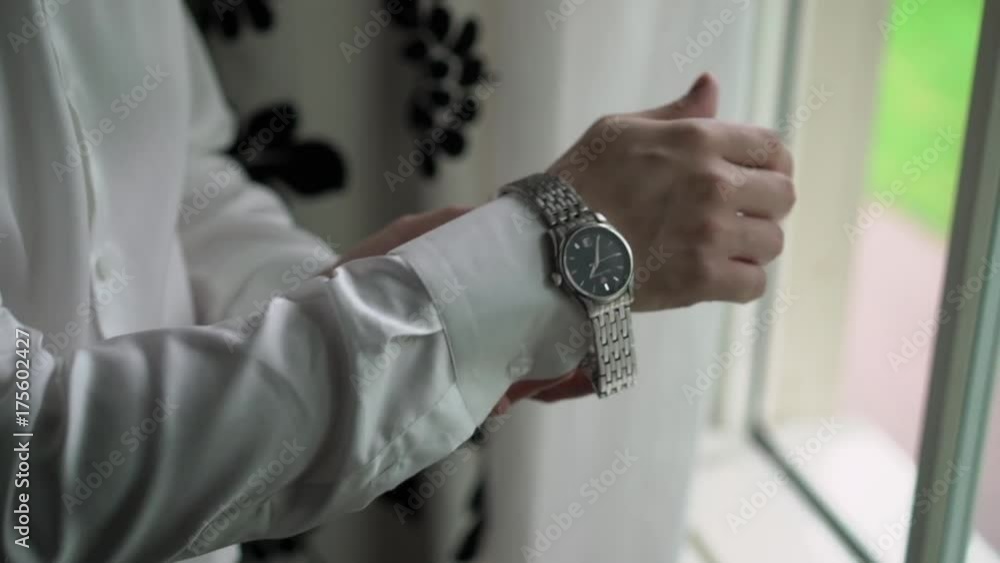 Man put on wrist watches closeup Man put on wrist watches closeup