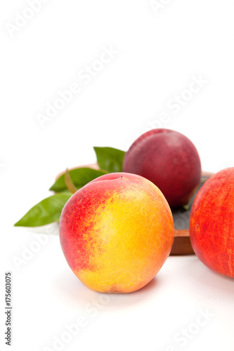 Freshly washed peach  on wooden cutting board isolated on white background