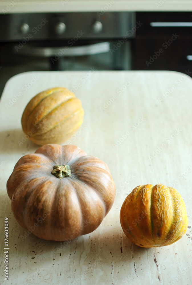 Halloween punpkin and melons background with copy space. Selective focus and bokeh. Halloween punpkin and melons background with copy space. Selective focus and bokeh.
