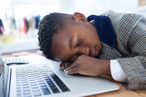 Businessman taking a nap on laptop