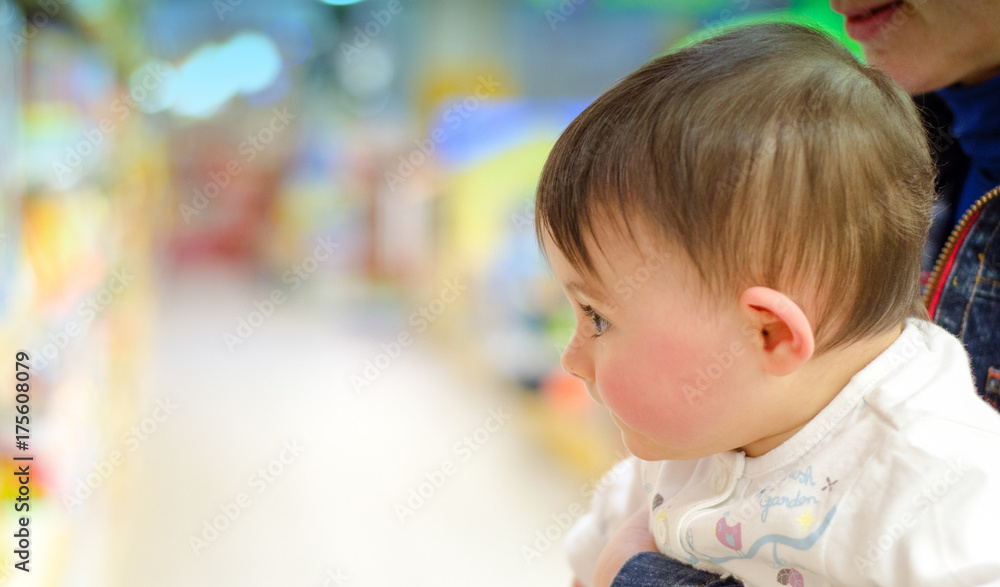 Baby Girl with her Mother in a Shop full of Toys Baby Girl with her Mother in a Shop full of Toys