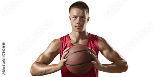 Basketball player hold a basketball ball. Isolated basketball player on a white background. Player wears unbranded clothes. © Alex