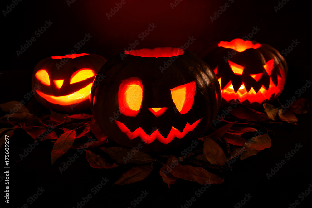 Halloween pumpkin lantern with dry leaves with burning candles Halloween pumpkin lantern with dry leaves with burning candles