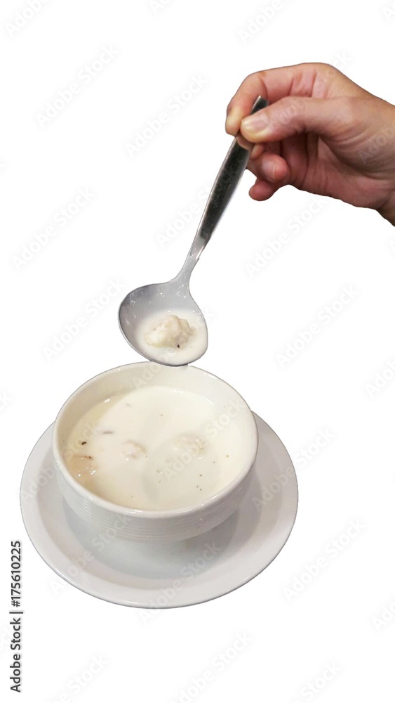 Cream soup in white cup with scoop isolated white background Cream soup in white cup with scoop isolated white background