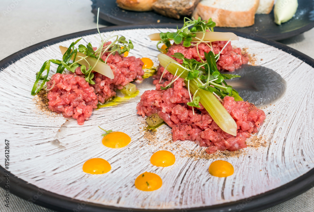 tasty Steak tartare (Raw beef) - classic steak tartare on white plate tasty Steak tartare (Raw beef) - classic steak tartare on white plate