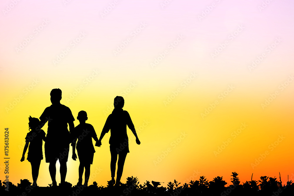 silhouette family walking on blurry colorful sky at sunset time silhouette family walking on blurry colorful sky at sunset time