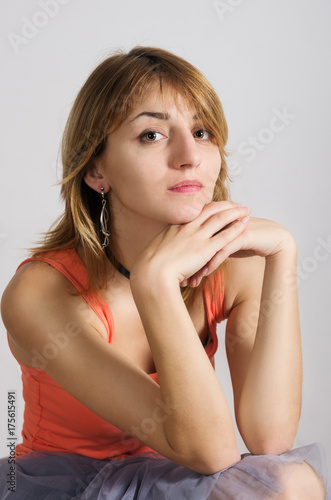 Portrait of red-haired girl in an orange shirt and a translucent blue skirt / The picture was taken in a studio, in Orenburg, Russia
