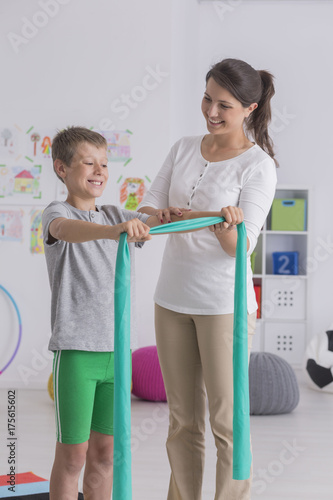 Fototapeta Naklejka Na Ścianę i Meble -  Boy doing exercise with elastic band