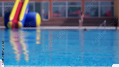 Boy resting and taiking sunbathe on a lounger in the aquapark near the pool
