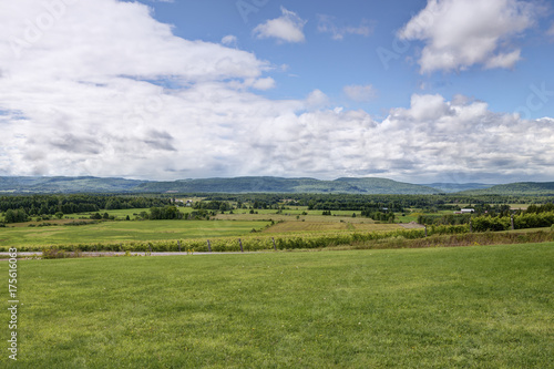 Summer landscape. Green fields, blue sky and mountains in background. © michelaubryphoto