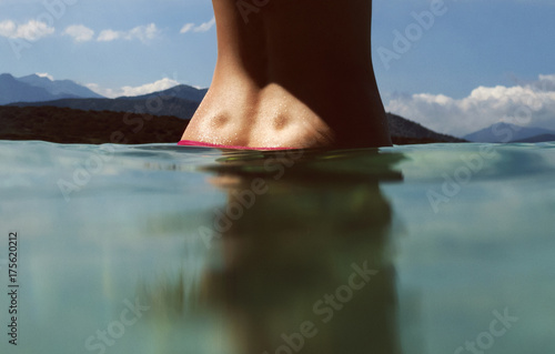 back with dimples of venus in the sea closeup photo