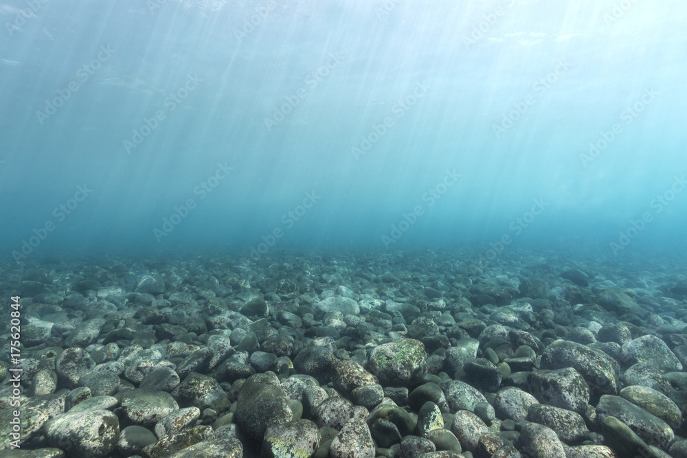 Black volcanic rocks at the bottom of the sea in bali