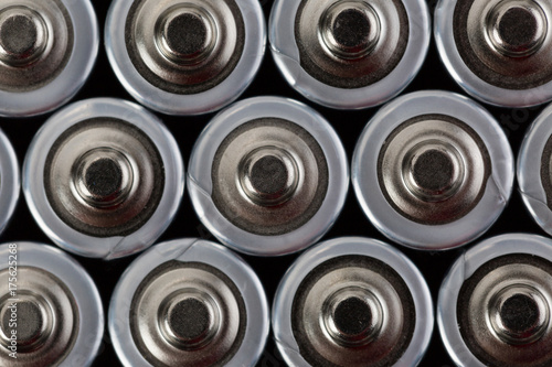 Close up top view on blurred rows of AA batteries energy abstract background of batteries. Shallow depth of field.