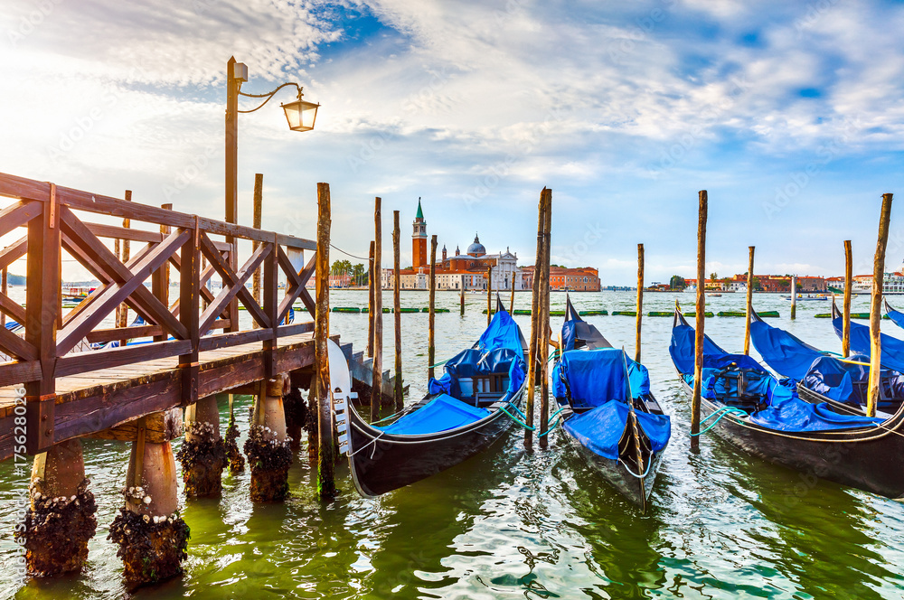 Gondolas near dock in Venice Italy with view to San Giorgio