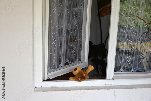 Abandoned toy, open window. photo