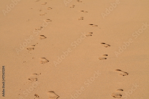 Walking side by side barefoot in the sand