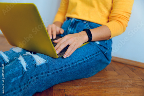 woman sitting on the floor with laptop photo