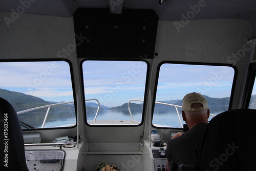 Older Man Driving A Boat Looking Out Window © Nellie