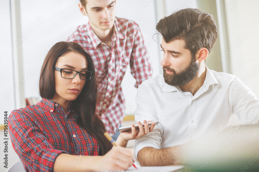 Focused people doing paperwork and using devices Focused people doing paperwork and using devices