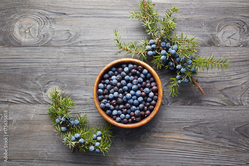 Juniper berries in a bowl with a sprig