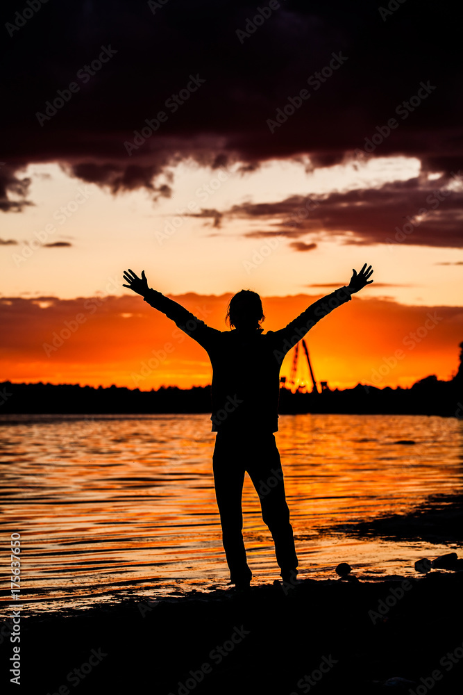 Silhouette of Man Raising His Hands or Open arms when sun rising up