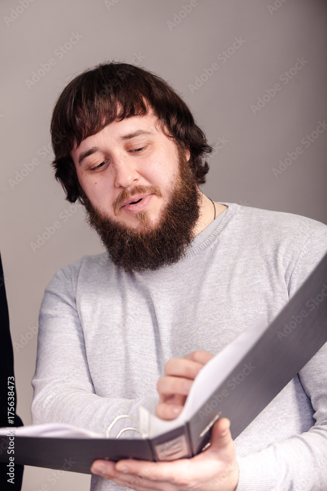 office worker shows report from his hands on with grey background