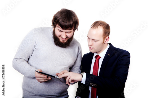 Business people planning work in office working on tablet computer, left guy shows to another man his plan