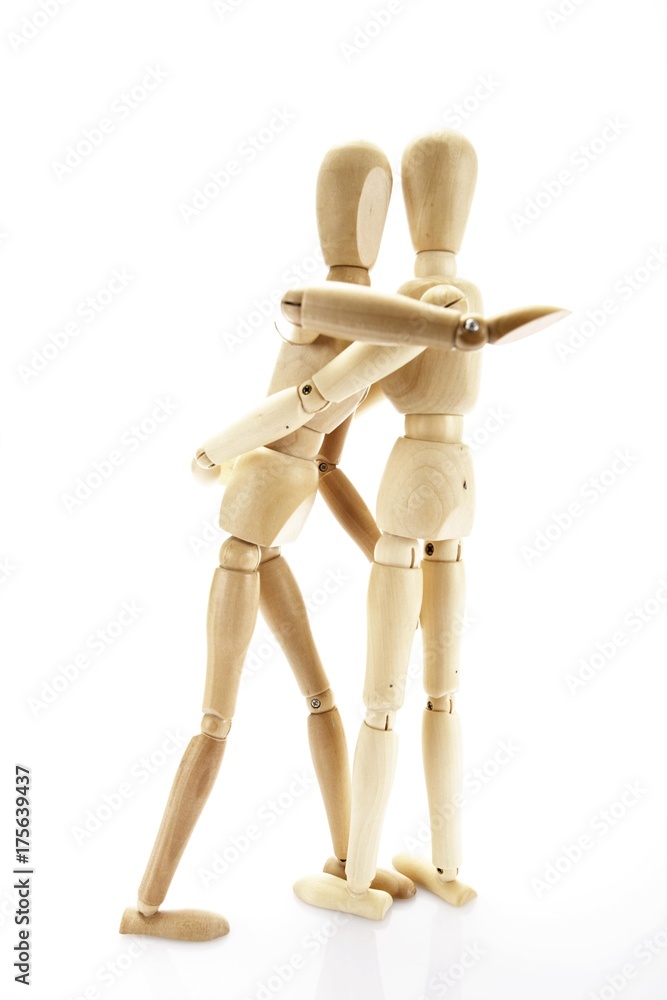 Two wooden jointed figures hugging each other Two wooden jointed figures hugging each other