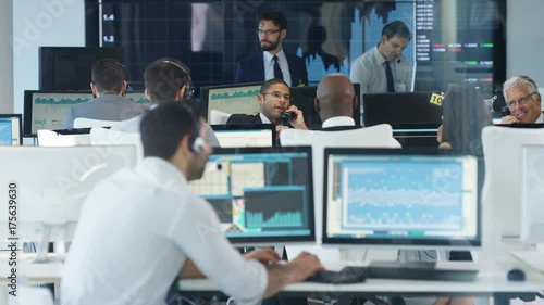  Financial trader in busy stock exchange celebrates making a successful deal