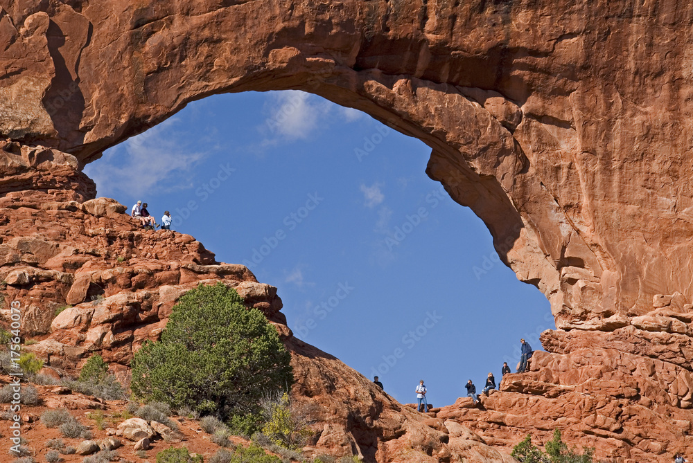 Tourists enjoy natural arch North Window in Arches National Park Utah USA