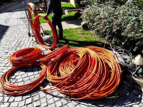 Orange fibre or fiber optic cables at garden for excavation
