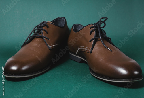 brown male shoes in green background
