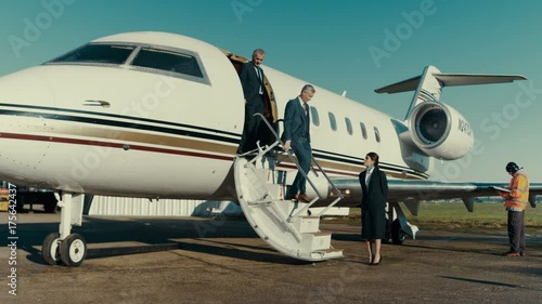  Mixed ethnicity VIP Businessmen disembarking from private jet photo