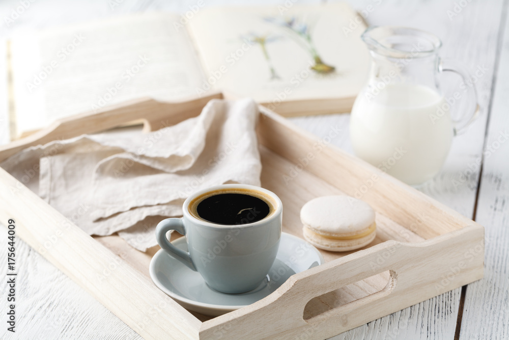 Morning breakfast, mug with coffee, book on a wooden tray Morning breakfast, mug with coffee, book on a wooden tray