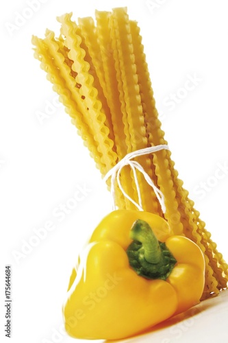 Bound bunch of Mafaldine pasta and a yellow bell pepper photo