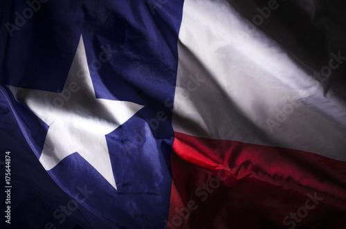 The Texas state flag waving in shadow